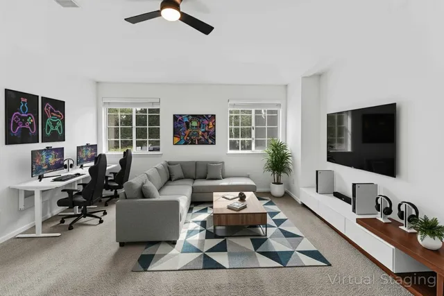 an empty room with windows and ceiling fan