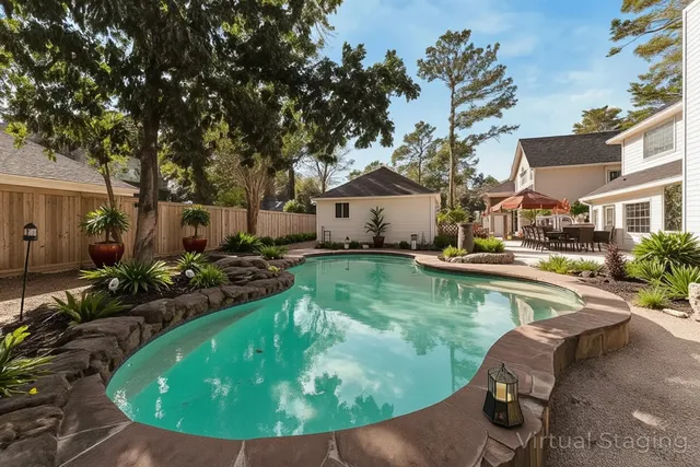 a view of a house with pool yard and sitting area