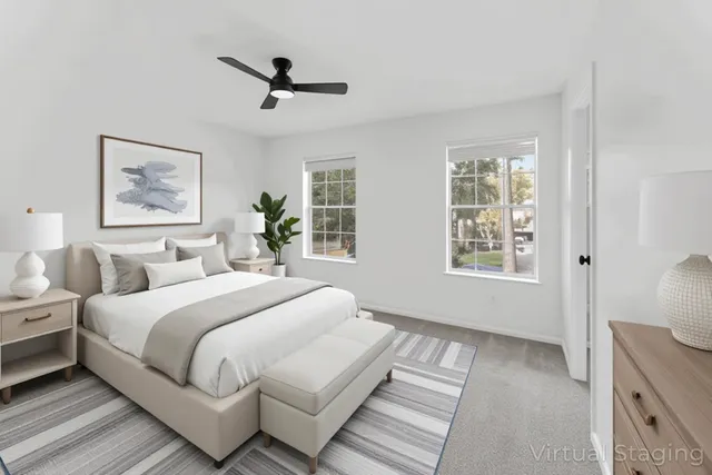a bedroom with two beds and a chandelier