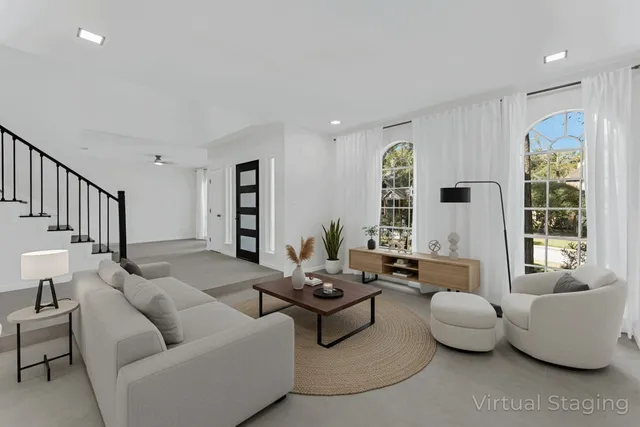 a living room with furniture and a large window