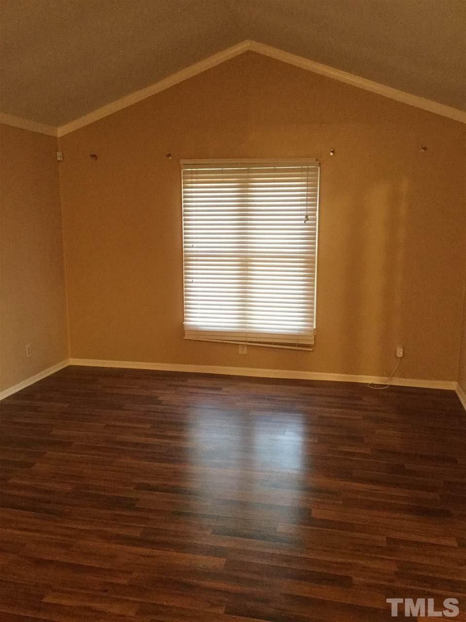 1522 Bennett Street Raleigh, NC 27604 - Photo 3 of 12 an empty room with wooden floor and windows