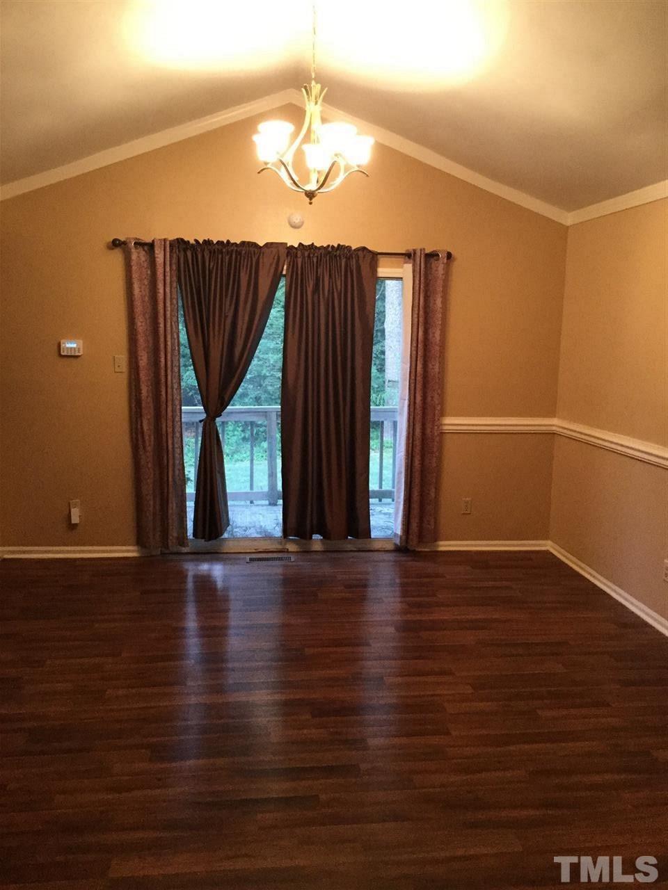 1522 Bennett Street Raleigh, NC 27604 - Photo 4 of 12 a view of an empty room with wooden floor and a window
