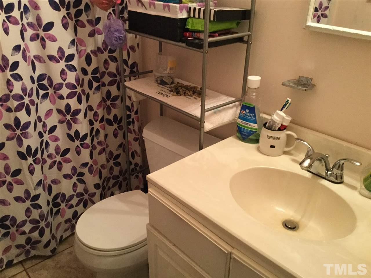 1522 Bennett Street Raleigh, NC 27604 - Photo 7 of 12 a bathroom with a sink toilet and shower