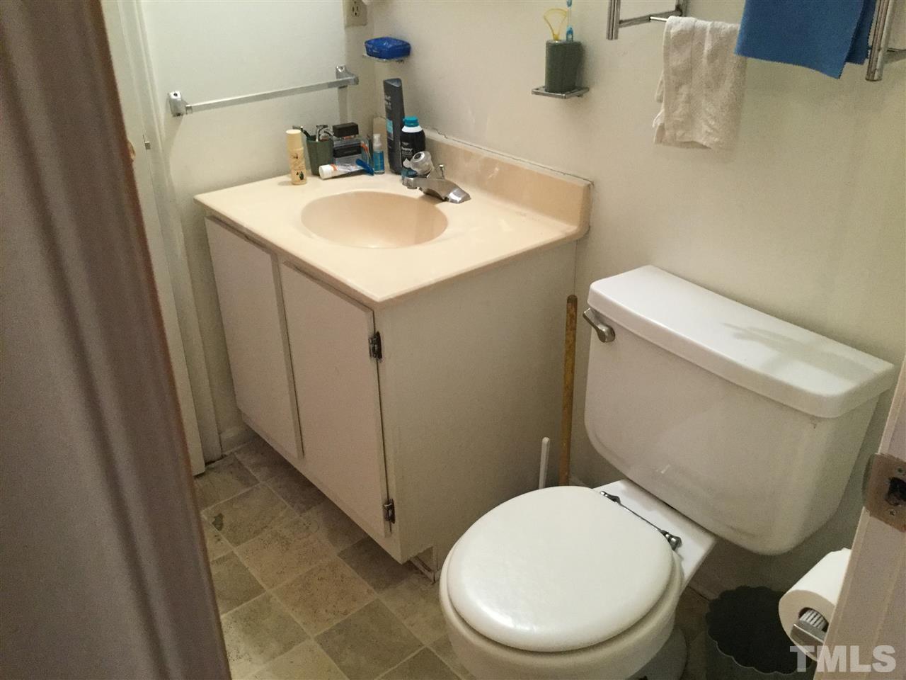 1522 Bennett Street Raleigh, NC 27604 - Photo 10 of 12 a white toilet sitting next to a bathroom sink
