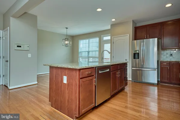 a kitchen with granite countertop stainless steel appliances and wooden cabinets