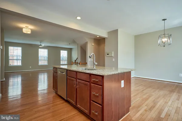 a view of kitchen with granite countertop cabinets and wooden floor