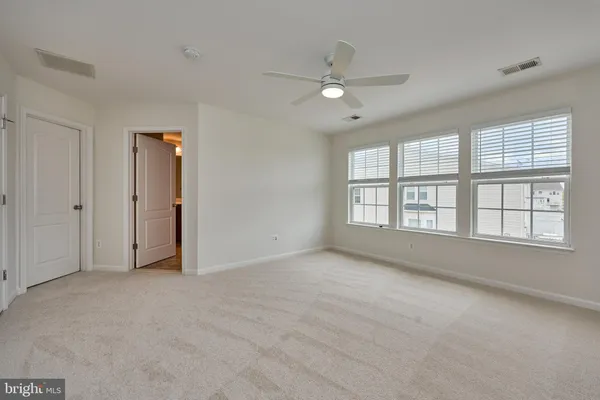 a bathroom with a bathtub shower sink mirror and toilet