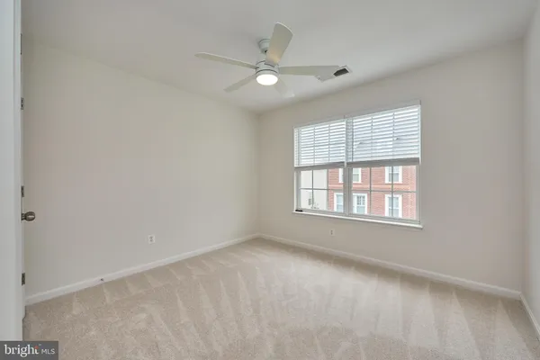 an empty room with window and pillar in it