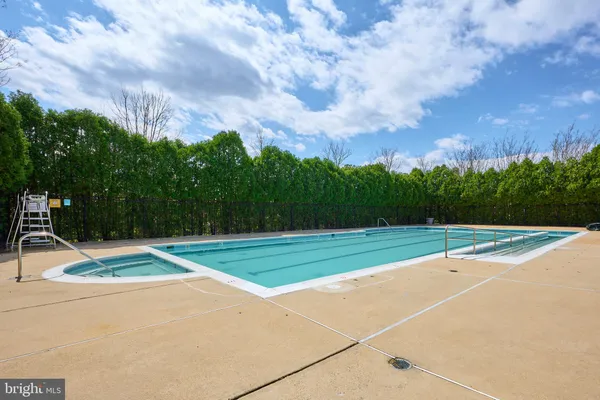 a front view of a house with a garden and trees