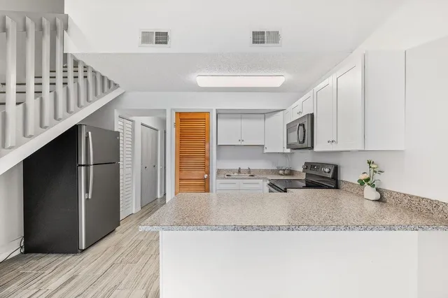 a view of kitchen with furniture and wooden floor