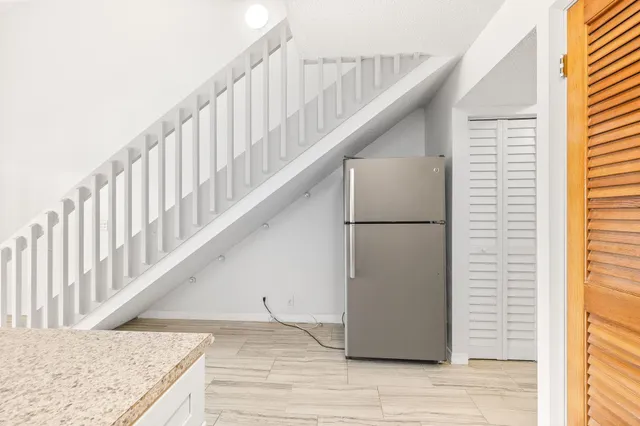 a view of staircase with white walls and a window