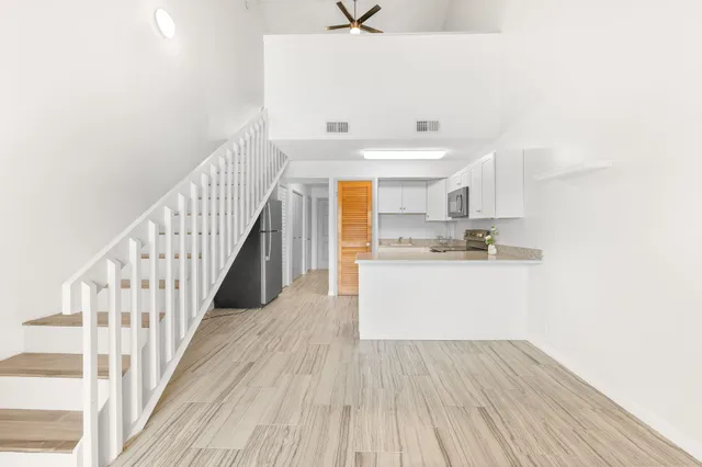 a view of a room with wooden floor