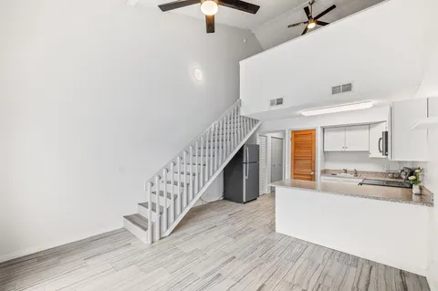 a bathroom with a sink a light fixture and a mirror