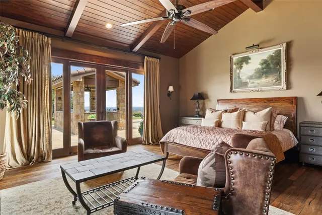 a living room with furniture a flat screen tv and a floor to ceiling window