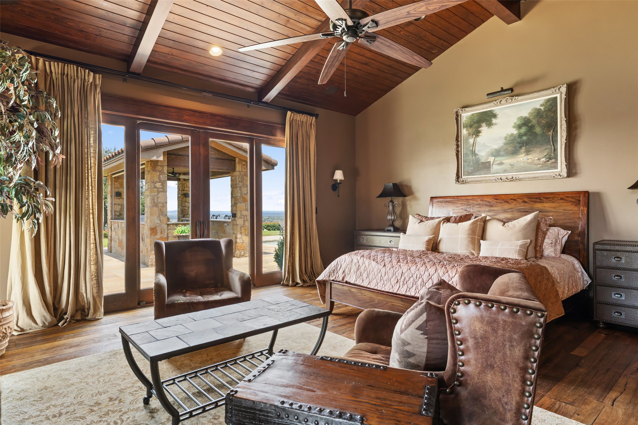 4529 Ranch Road 3347 Round Mountain, TX 78663 - Photo 12 of 36 a living room with furniture a flat screen tv and a floor to ceiling window