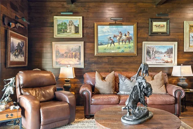 a living room with furniture and a painting