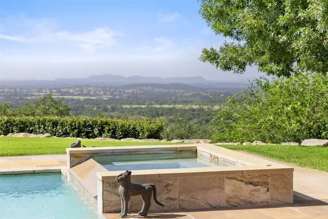 a view of a swimming pool with a yard