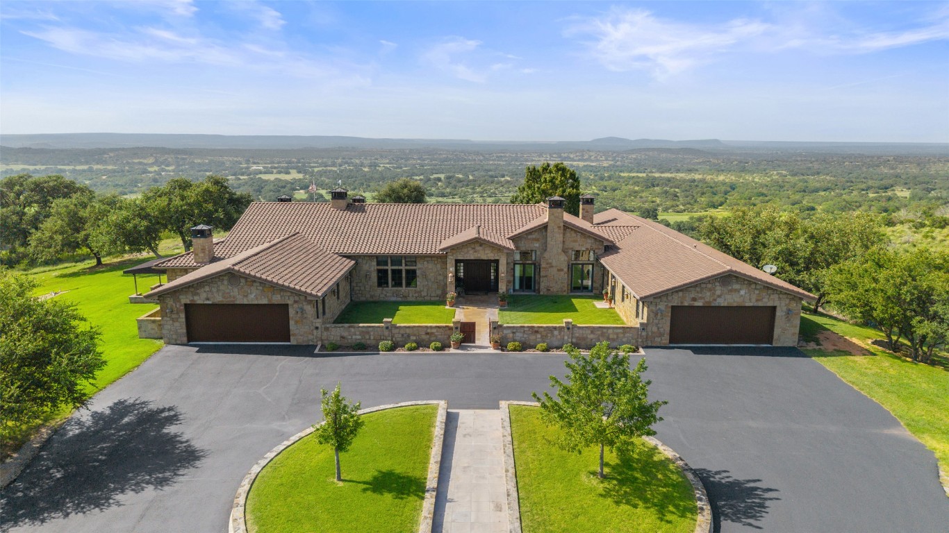 4529 Ranch Road 3347 Round Mountain, TX 78663 - Photo 2 of 36 a aerial view of a house with a big yard and large trees