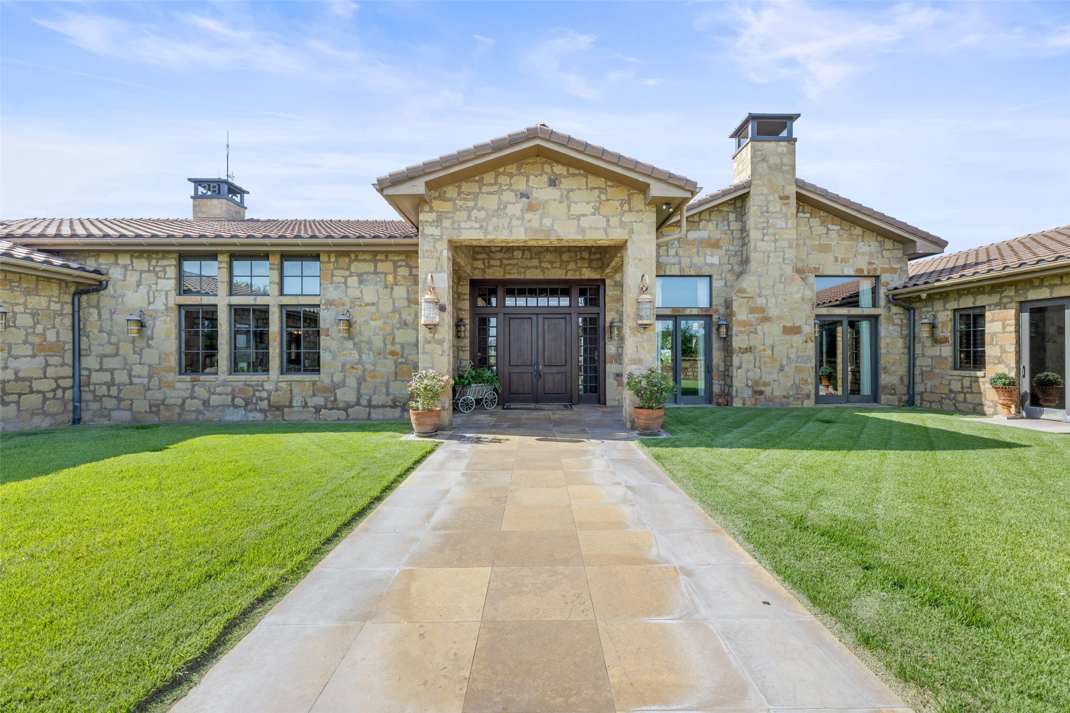 4529 Ranch Road 3347 Round Mountain, TX 78663 - Photo 4 of 36 a front view of a house with a garden and yard