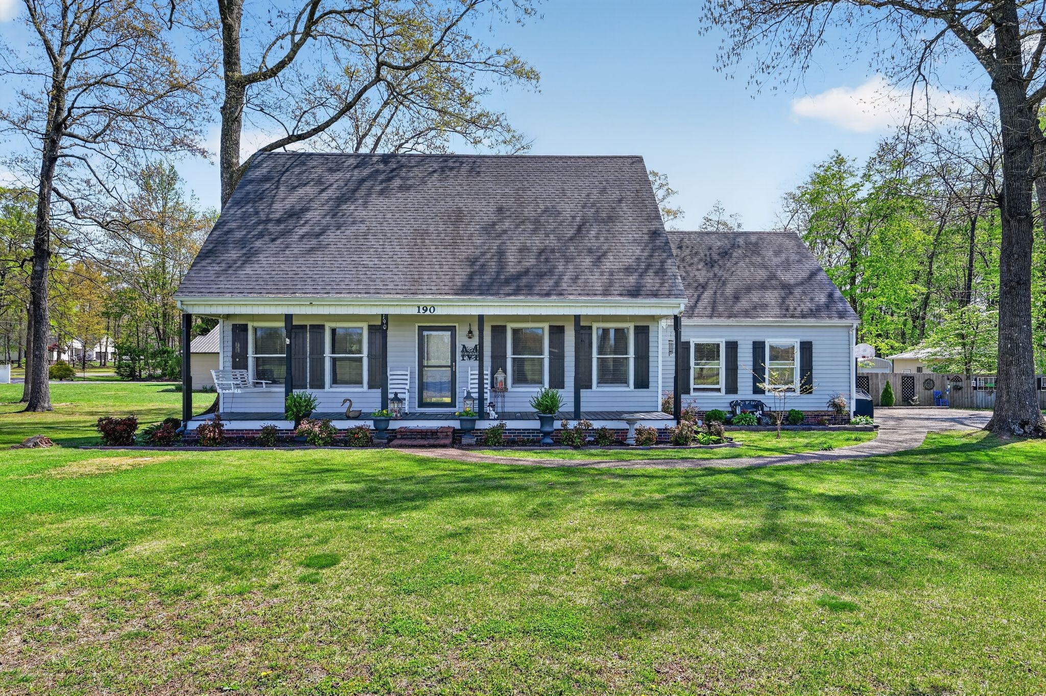 a front view of a house with a garden and patio