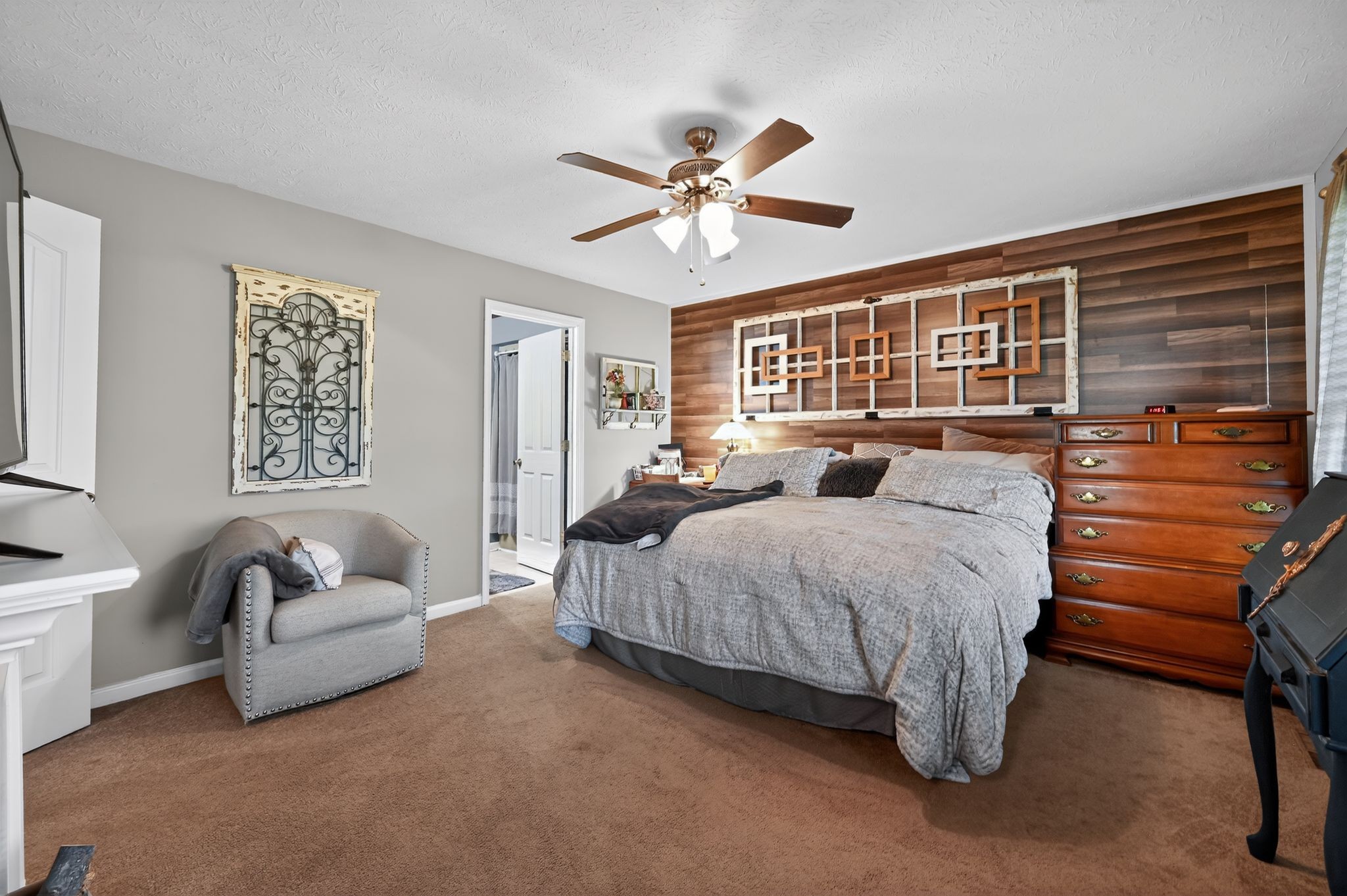 190 Hooper Road Smithville, TN 37166 - Photo 13 of 32 a spacious bedroom with a bed a couch and a window