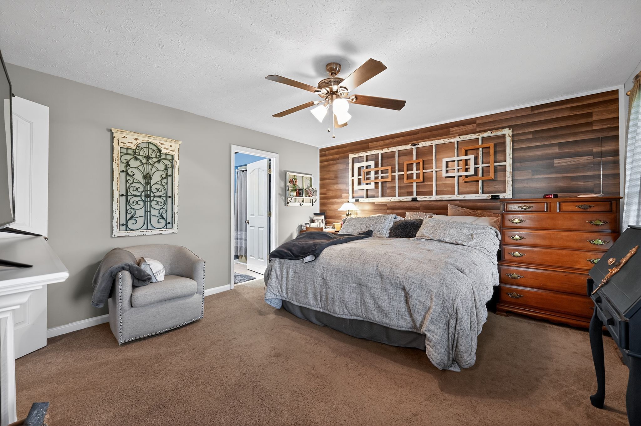 190 Hooper Road Smithville, TN 37166 - Photo 14 of 32 a spacious bedroom with a bed a couch and a window