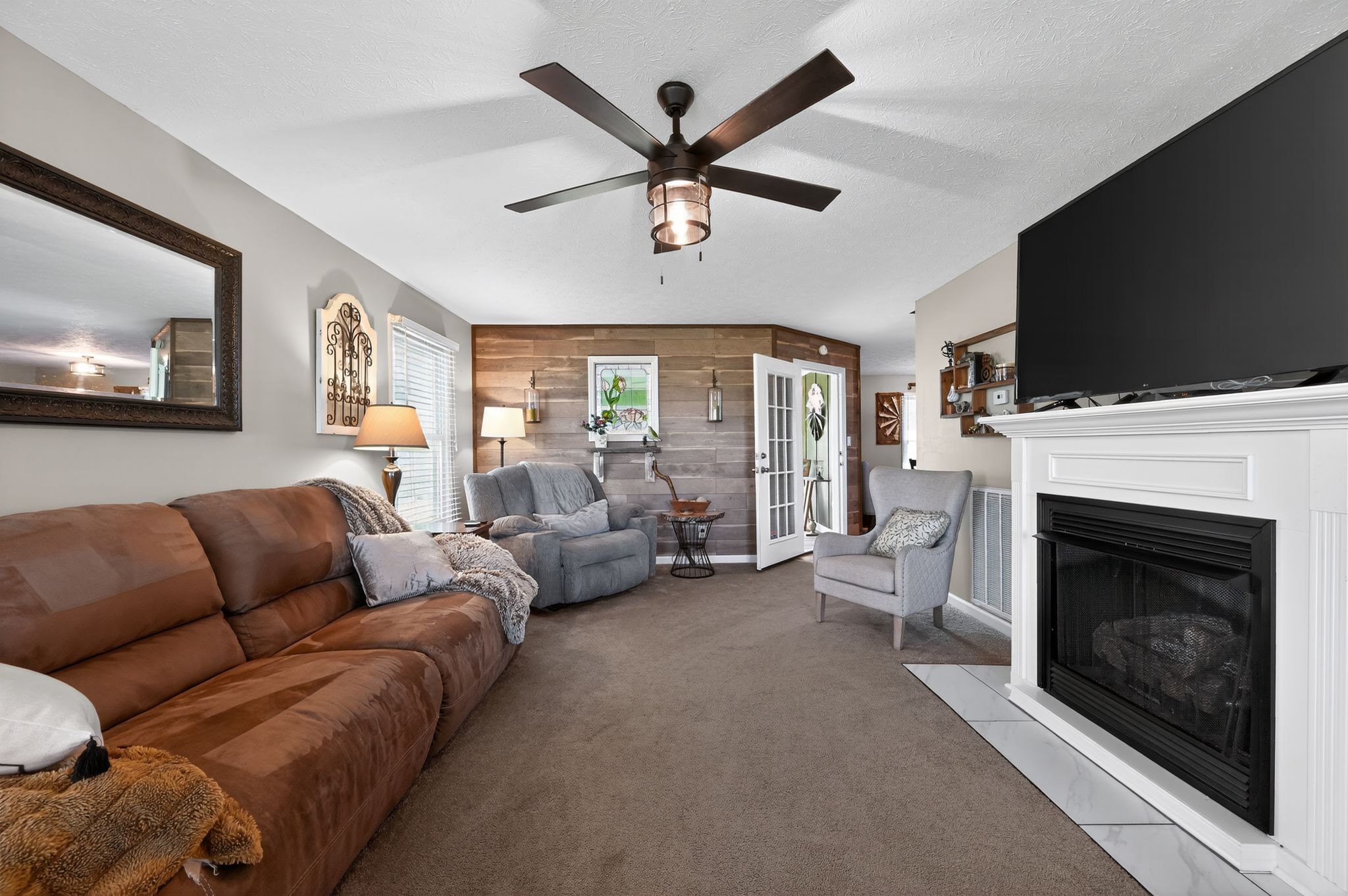 190 Hooper Road Smithville, TN 37166 - Photo 7 of 32 a living room with furniture a flat screen tv and a fireplace