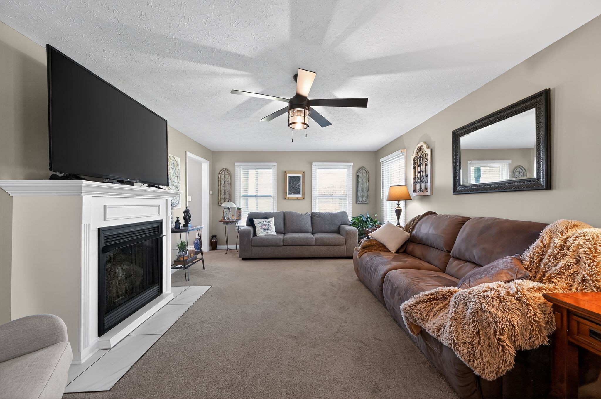 190 Hooper Road Smithville, TN 37166 - Photo 8 of 32 a living room with furniture a flat screen tv and a fireplace
