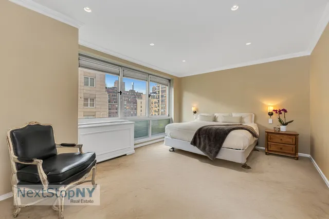 a bedroom with a bed and chair