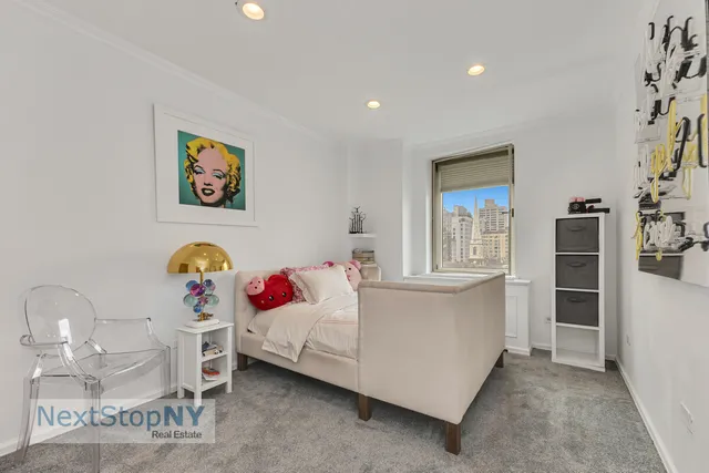 a bedroom with a bed and cabinets