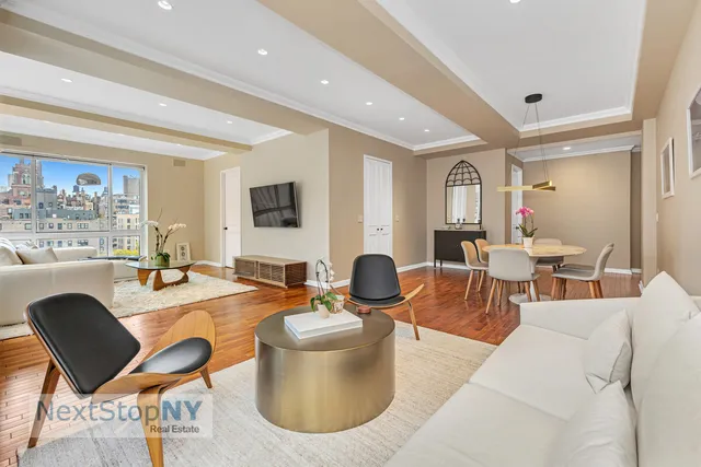 a living room with fireplace furniture and a large window