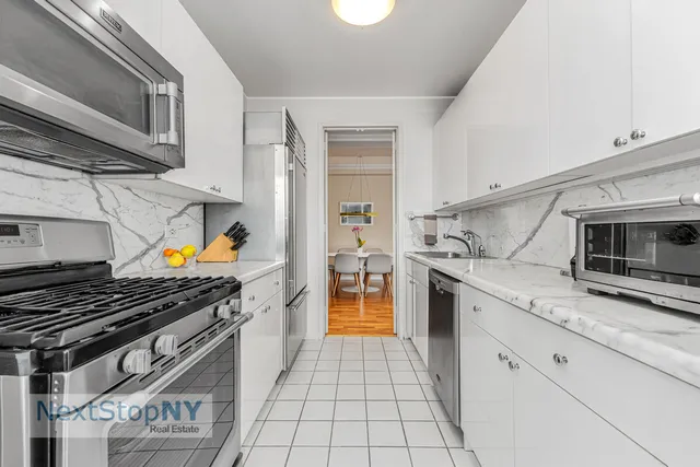 a kitchen with stainless steel appliances granite countertop a stove and a microwave