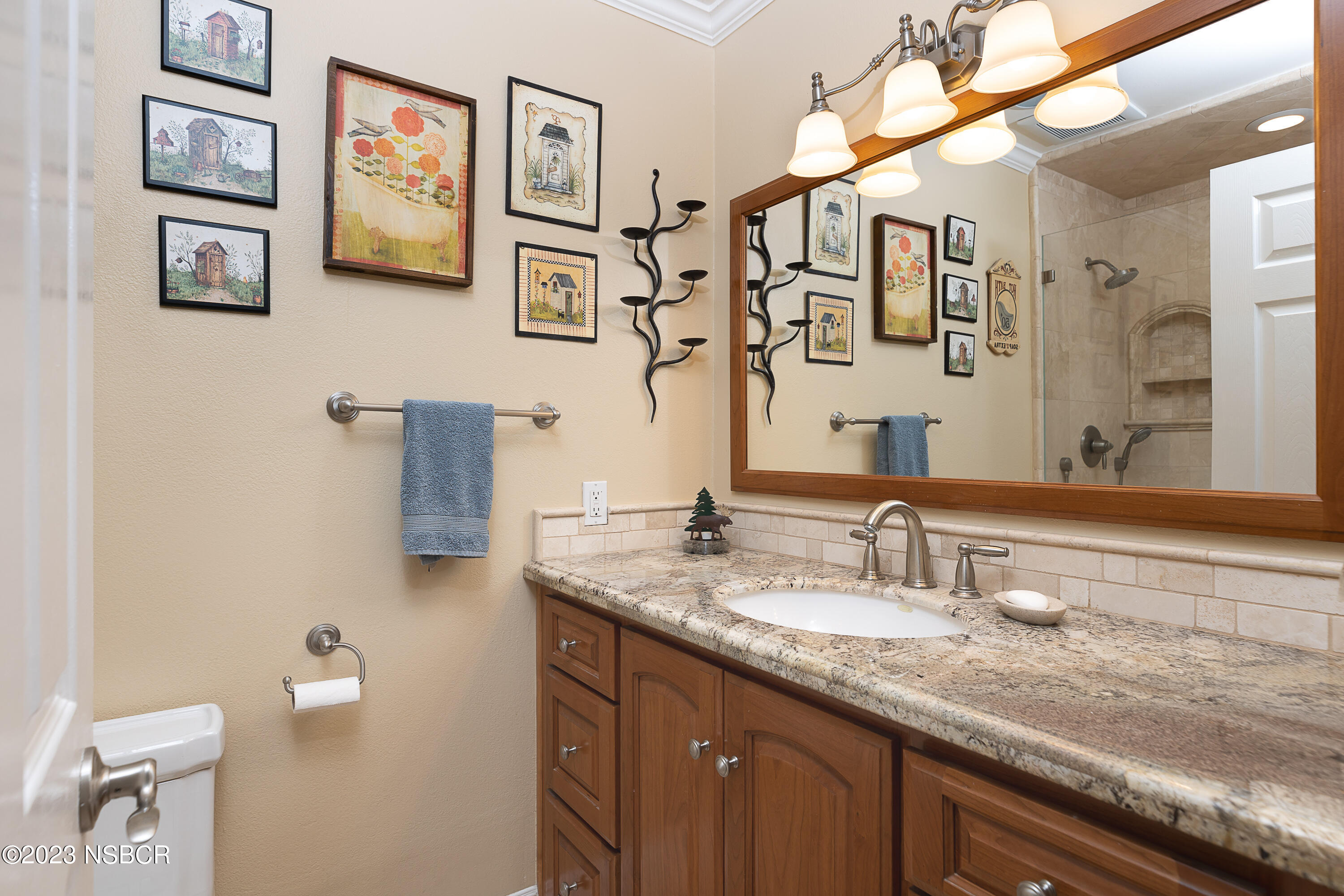 629 Wakefield Road Goleta, CA 93117 - Photo 15 of 22 a bathroom with a granite countertop sink a mirror and a toilet