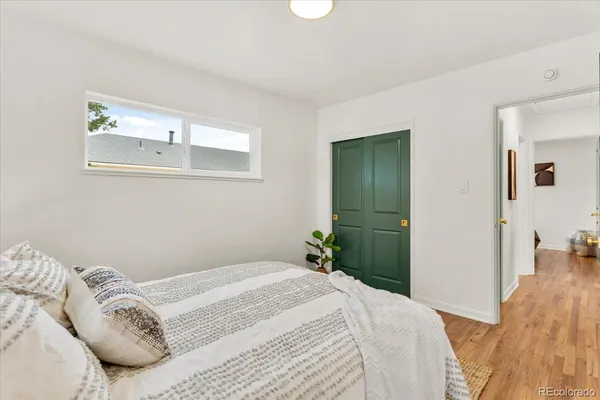a bedroom with a bed and a mirror