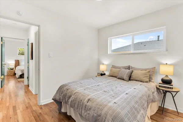 a bedroom with a bed and wooden floor