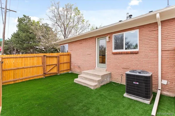 a view of backyard with a chair and a yard