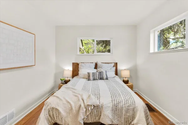 a bedroom with bed and cupboard