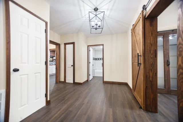 a view of hallway with wooden floor