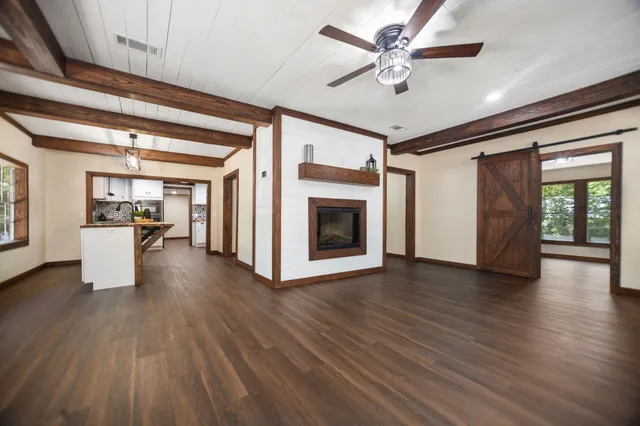 a view of a livingroom with furniture hardwood floor and a ceiling fan