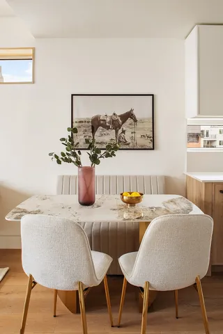 a dining room with furniture and wooden floor