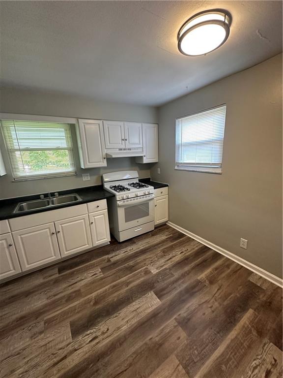 908 Russellwood Avenue McKees Rocks, PA 15136 - Photo 14 of 33 a kitchen with kitchen island a stove a sink and a window