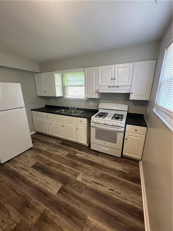 908 Russellwood Avenue McKees Rocks, PA 15136 - Photo 15 of 33 a kitchen with granite countertop a stove a sink and a microwave