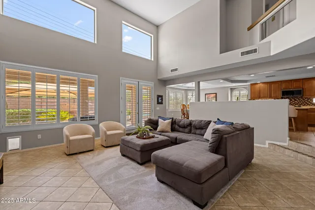 a living room with furniture a table and wooden floor