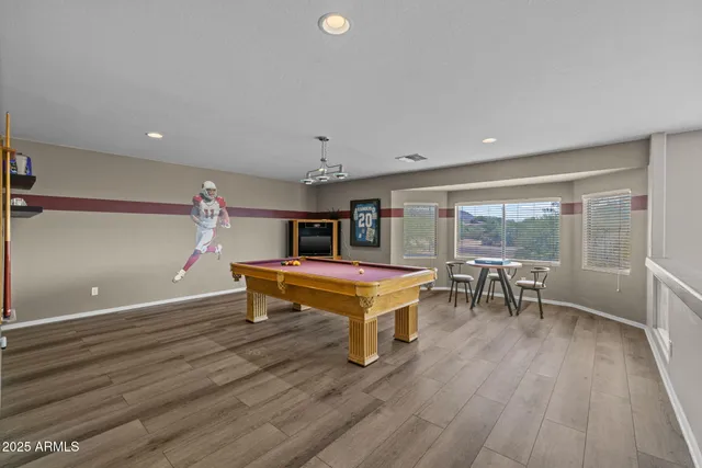 a backyard of a house with table and chairs under an umbrella