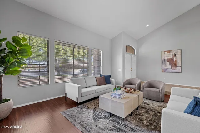 a bedroom with a large bed a chandelier and a window
