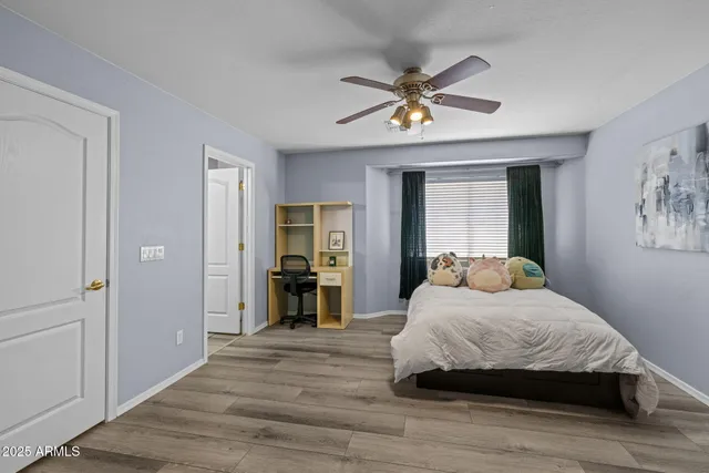 a bedroom with furniture and a flat screen tv