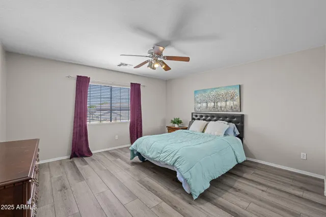 a bedroom with a bed and wooden floor