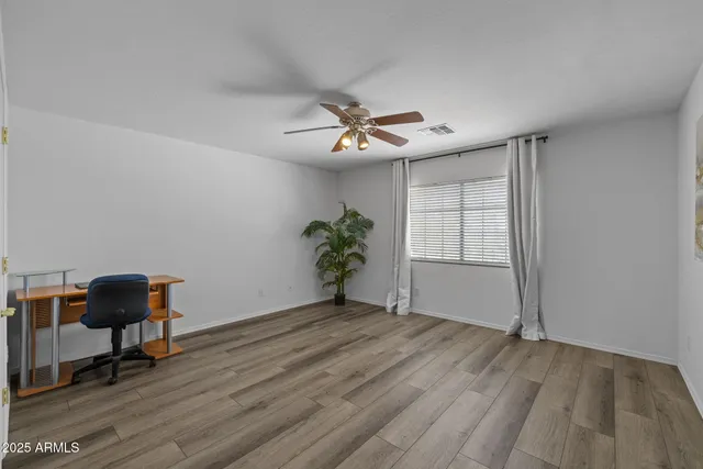a spacious bathroom with a double vanity sink a large mirror and shower