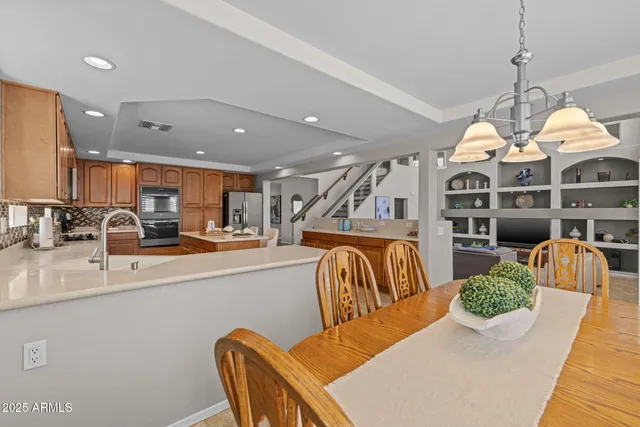 a kitchen with stainless steel appliances white cabinets and a potted plant