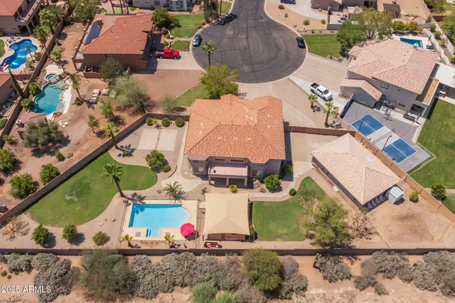a kitchen with stainless steel appliances granite countertop a table chairs sink refrigerator and cabinets